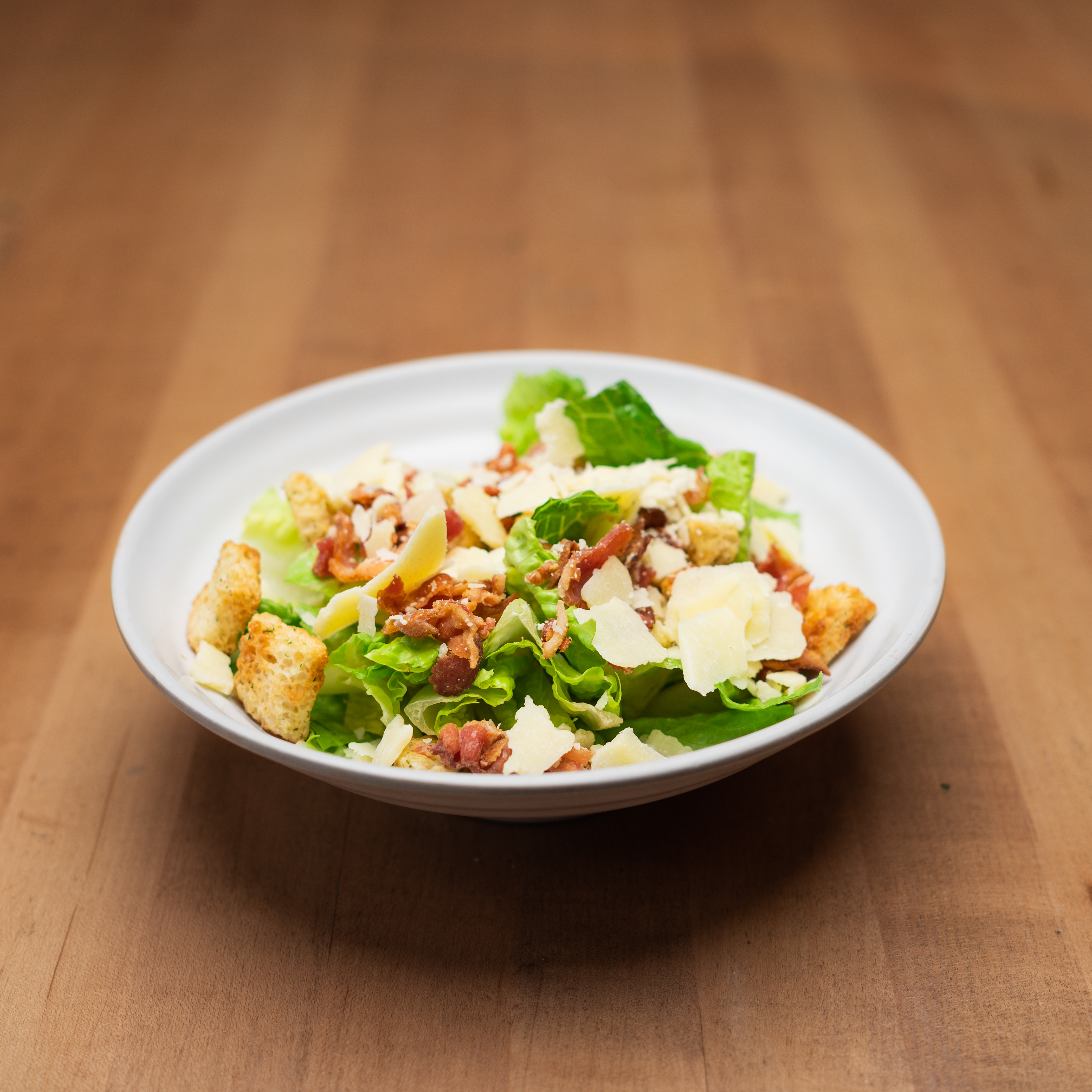 Caesar Salad - Crisp romaine, shaved parmesan, smoky bacon & gold...
